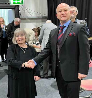 Band secretary Ruth Davies is congratulated by adjudicator Philip Norley (left) and (right)