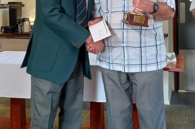 Seniors Captain Alan Bridges, presents Ken Lawrence with the Roy Powell Away Day Trophy.