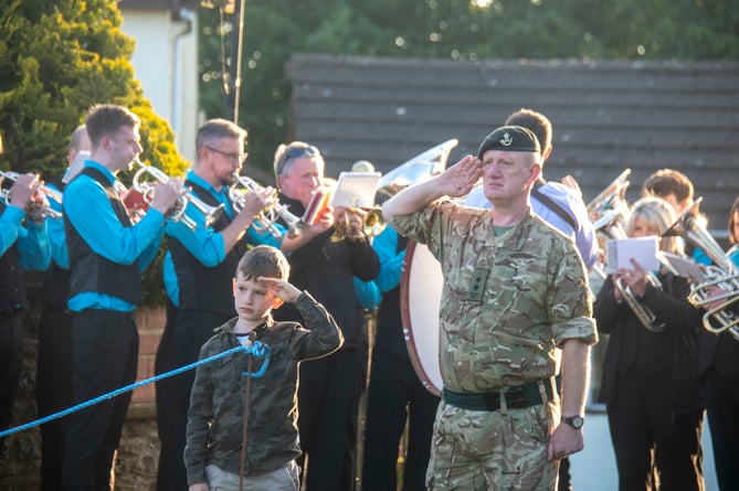 Lyn Jones of the Gloucestershire Army Cadet force and son Calan take the salute during the National Anthem at Ruardean.