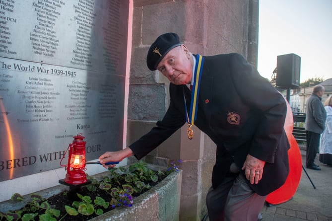 Paul McMahon of Coleford British Legion lights the town's peace lantern.