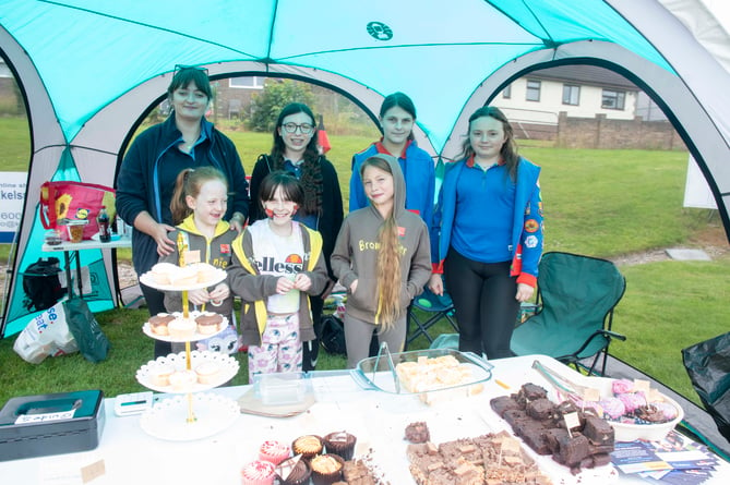 Guides and Brownies on the cake stall.