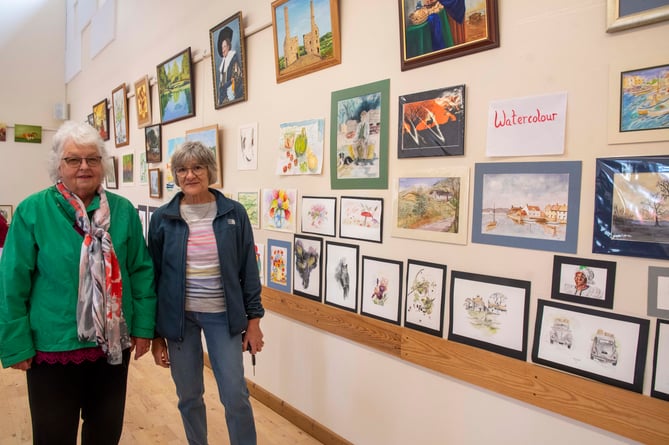 Diana Wakefield and Sheila Harris with works by members of the group. 