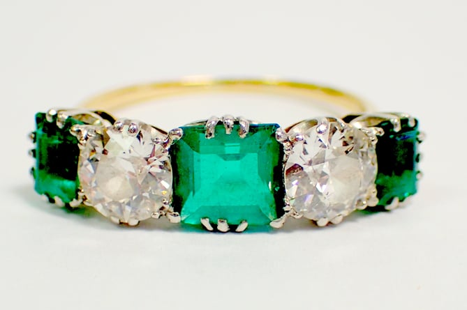 A fine diamond and emerald ring